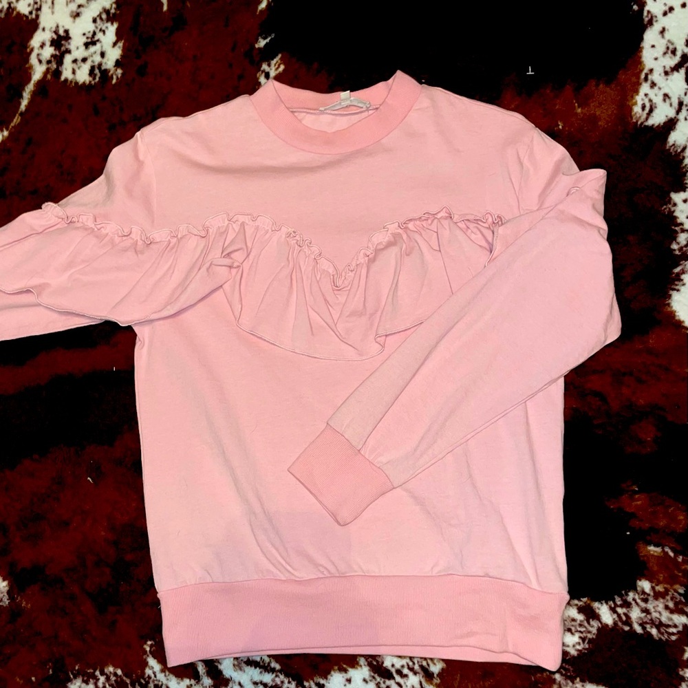 Pink ruffle long sleeve shirt.